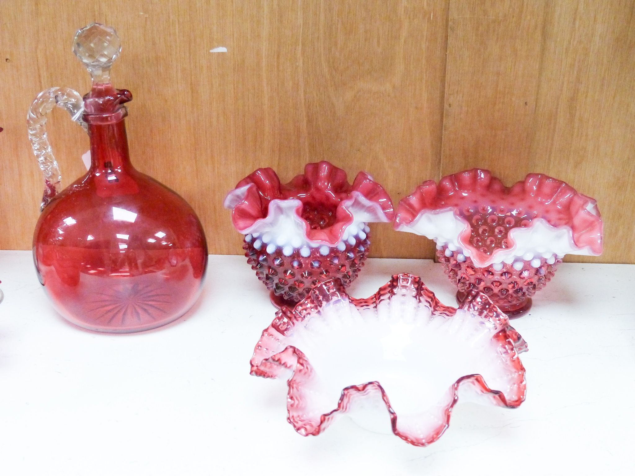 A group of Victorian Cranberry glass dishes, two vases and a Claret jug, tallest 23.5 cm (7)